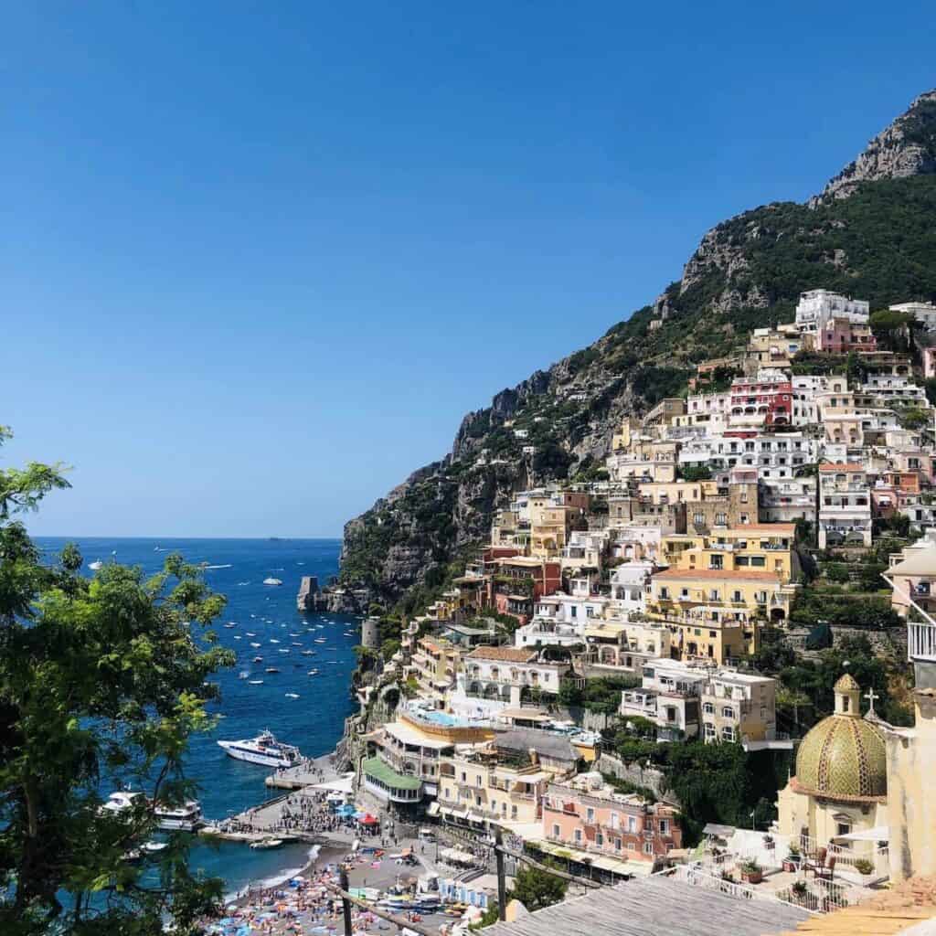 Beautiful Positano cliffside village on Amalfi Coast in southern Italy against cloudless blue sky on sunny day