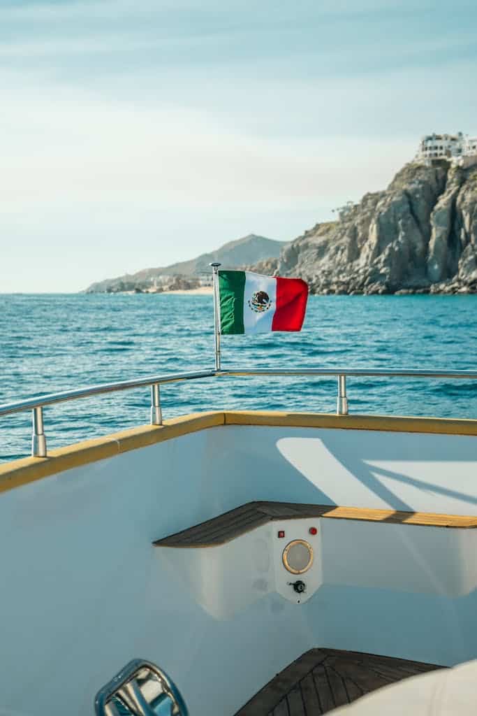 A mexican flag on the bow of a boat