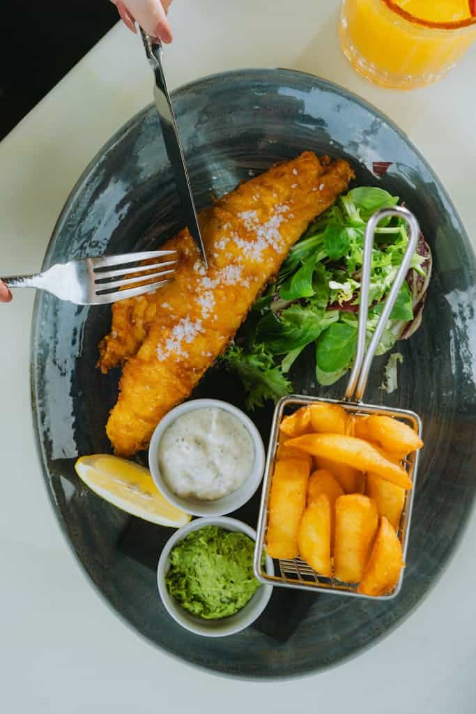 A plate with fish and chips and a fork