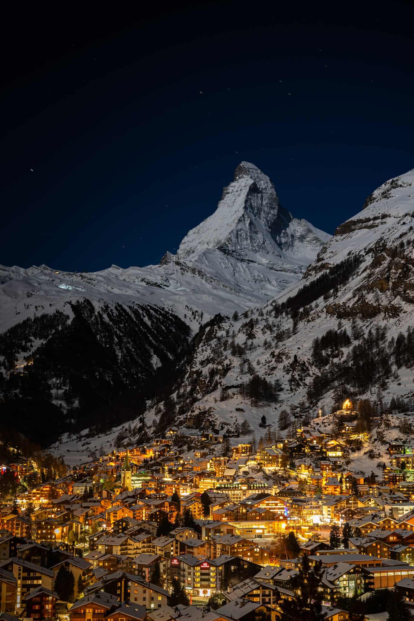 Aerial View of City Buildings Near Snow Covered Mountain